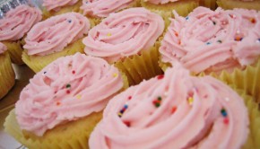Yellow cake cupcakes with pink sprinkle frosting
