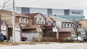 A big Humber College sign looms behind houses in the Rexdale area. If you were a resident of the area, you might perceive this as impending doom -- but students say that is just how Rexdale is.