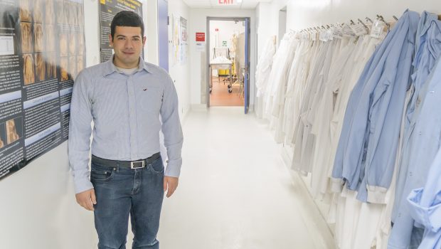 PhD candidate William Albabish stands in a hallway at the University of Guelph Human Anatomy lab.
